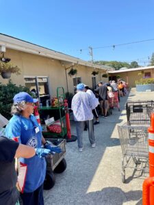 Neighbors wait for a food distribution.