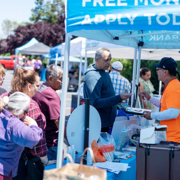 People in line at a CalFresh outreach booth.