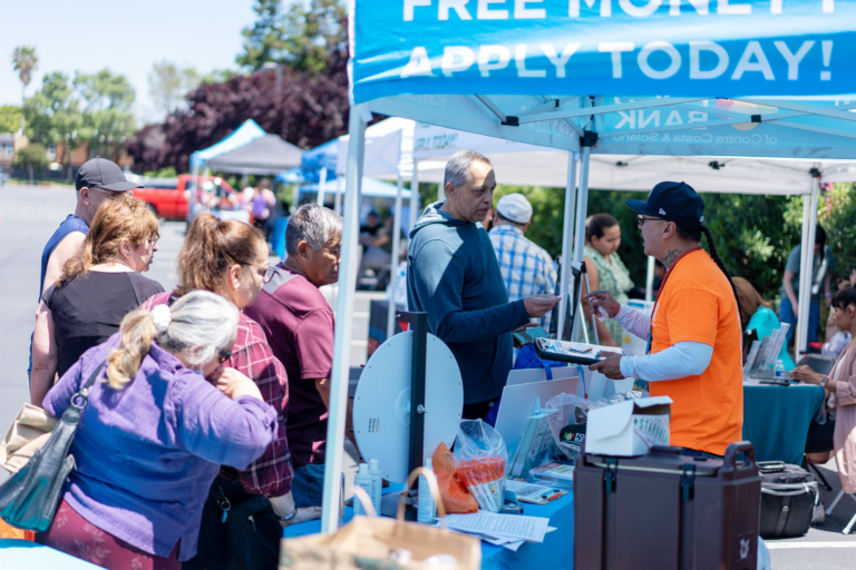 People in line at a CalFresh outreach booth.