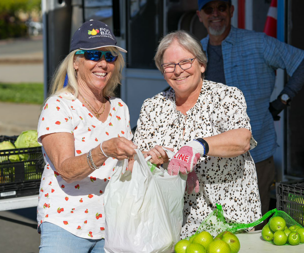 Two women volunteer with the Food Bank.