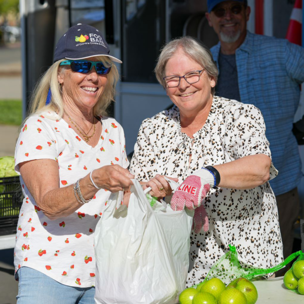 Two women volunteer with the Food Bank.