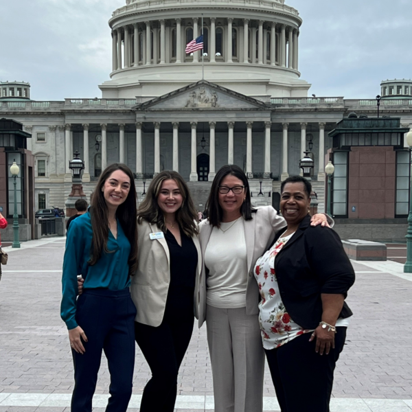 Four women post in front of the Capitol Building in Washington, D.C.