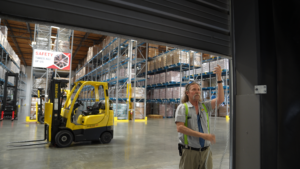 A staff member works in our Food Bank warehouse.