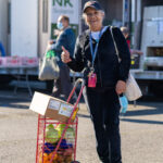 Client receives fresh produce and food at Food Bank distribution.