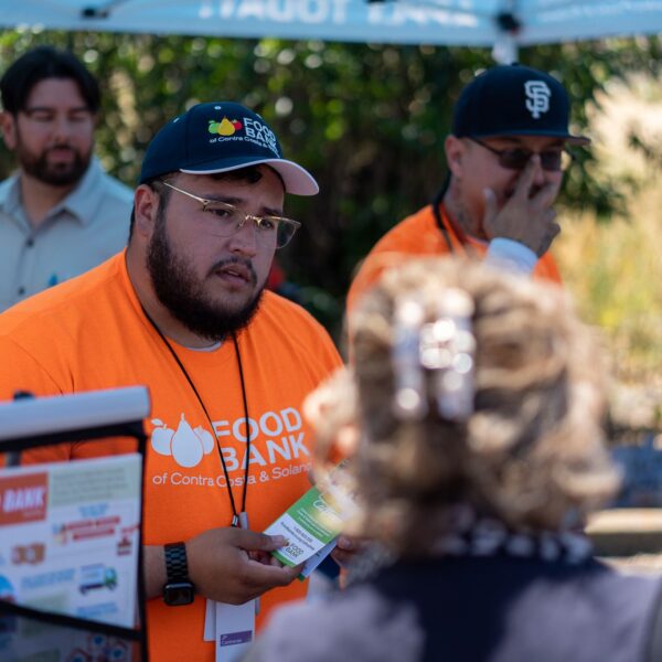 A member of the Food Bank CalFresh Team talks to the public.