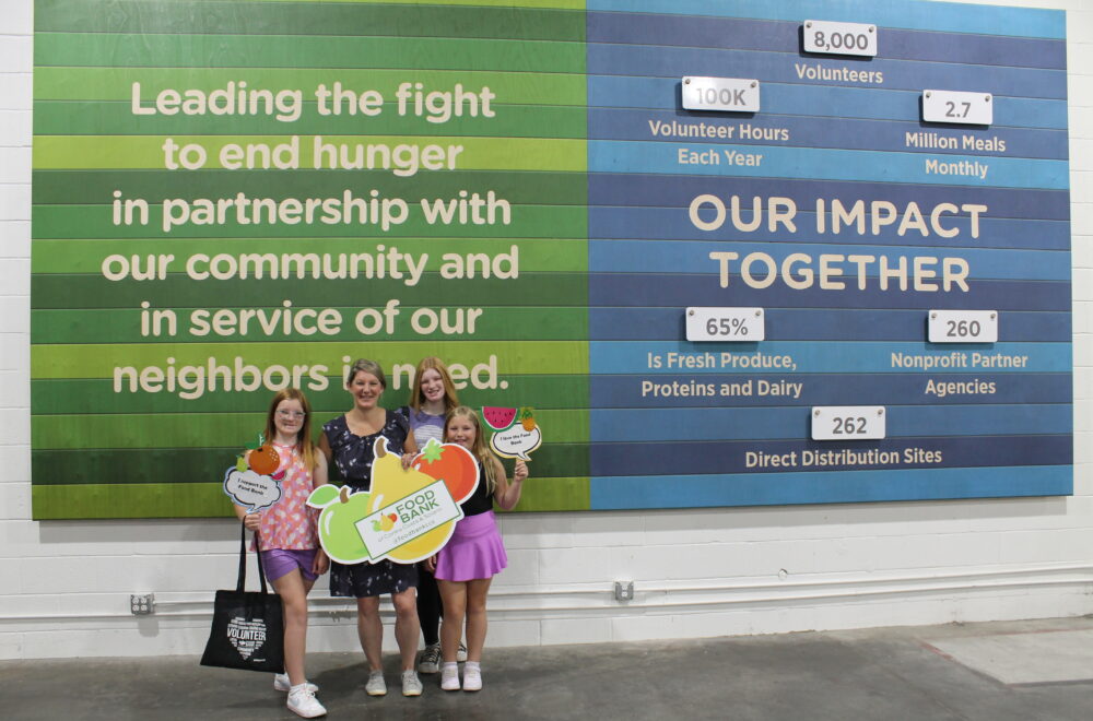 Staff talk to a visitor in the Food Bank Volunteer Center.