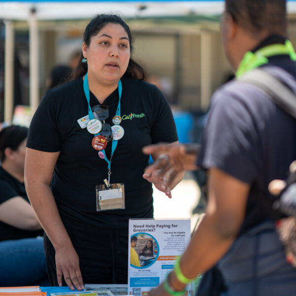 CalFresh outreach specialist talks to a neighbor.