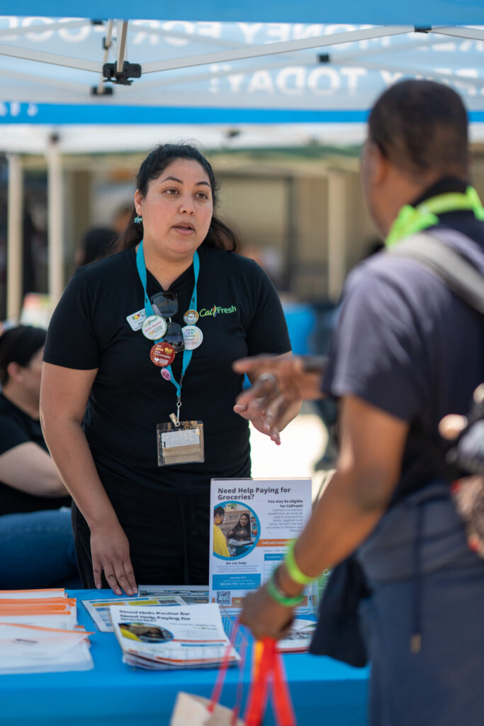 CalFresh outreach specialist talks to a neighbor.