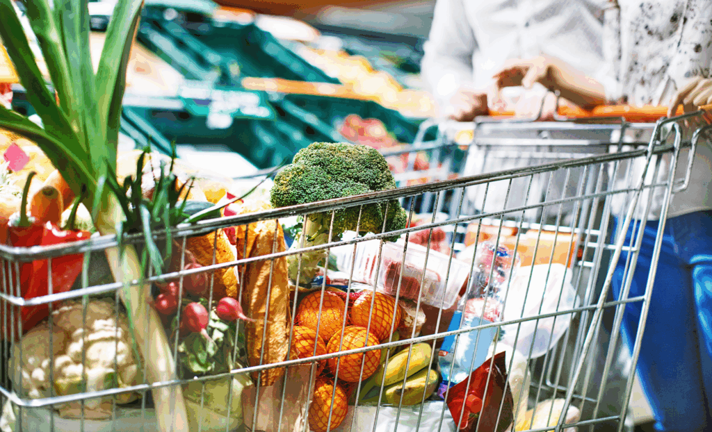 A shopping cart filled with food.