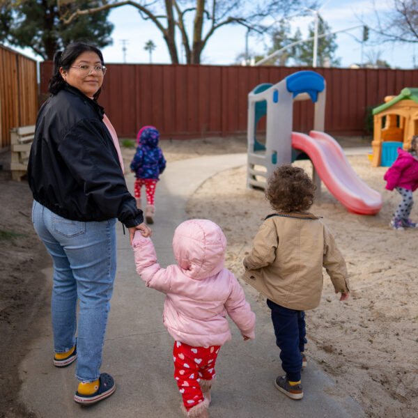 A childcare worker plays with children at Bay Area Crisis Nursery.