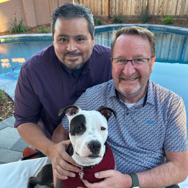 Ken Wood and his partner pose with his dog.